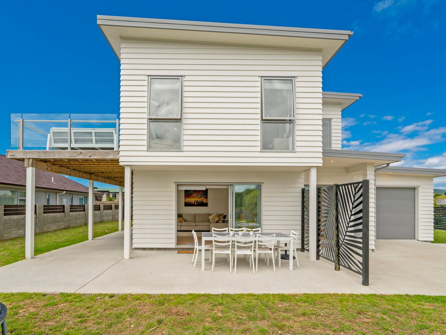 Coastal Pearl luxury holiday home exterior at dusk in Matarangi, Coromandel